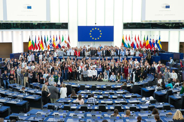 Jongeren komen samen voor een groepsfoto in de grote vergaderzaal van het Europees Parlement in Straatsburg.